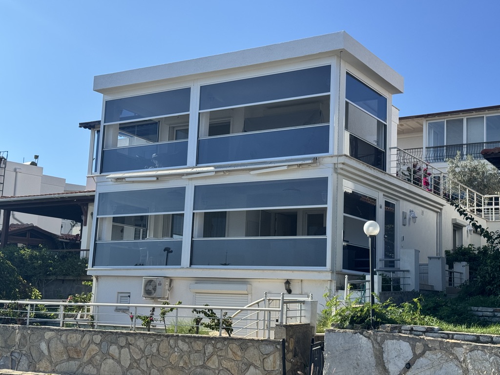 House in Bodrum after the renovation — glazed, light-filled rooms